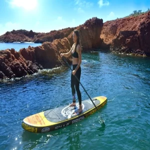 A woman stands steadily on a Sup Paddle Inflatable Key West Pride 10.4